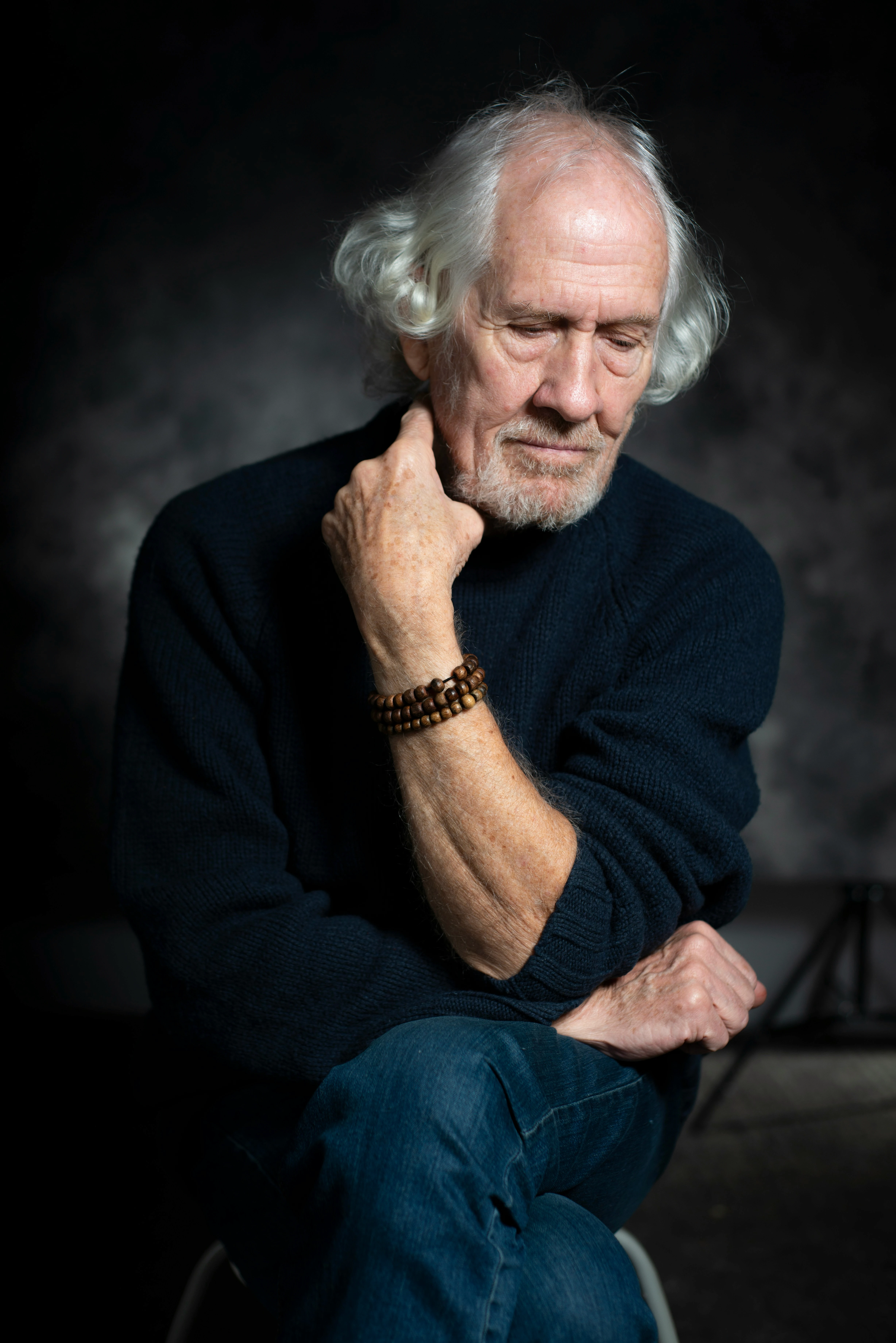 man in black long sleeve shirt sitting on chair