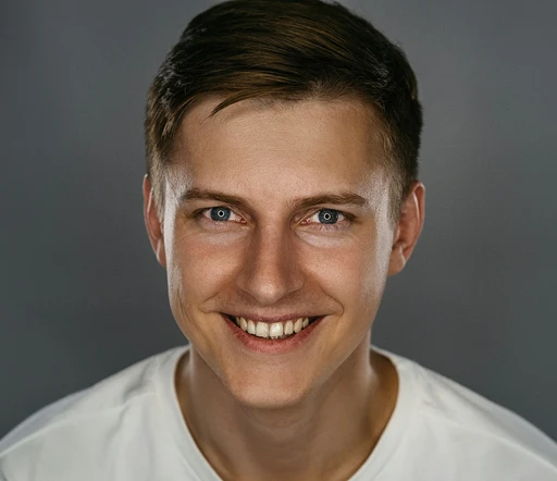 man in white crew neck shirt smiling